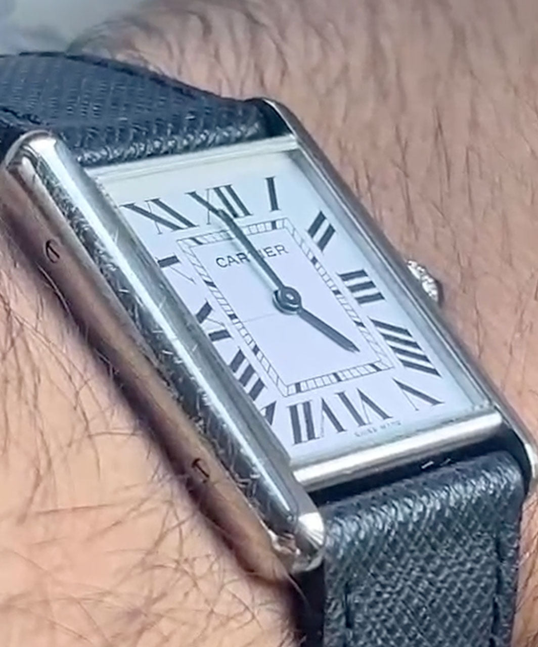 Stainless steel Cartier watch with scratches on the case, before polishing with Buhron jewellery polishing cloth