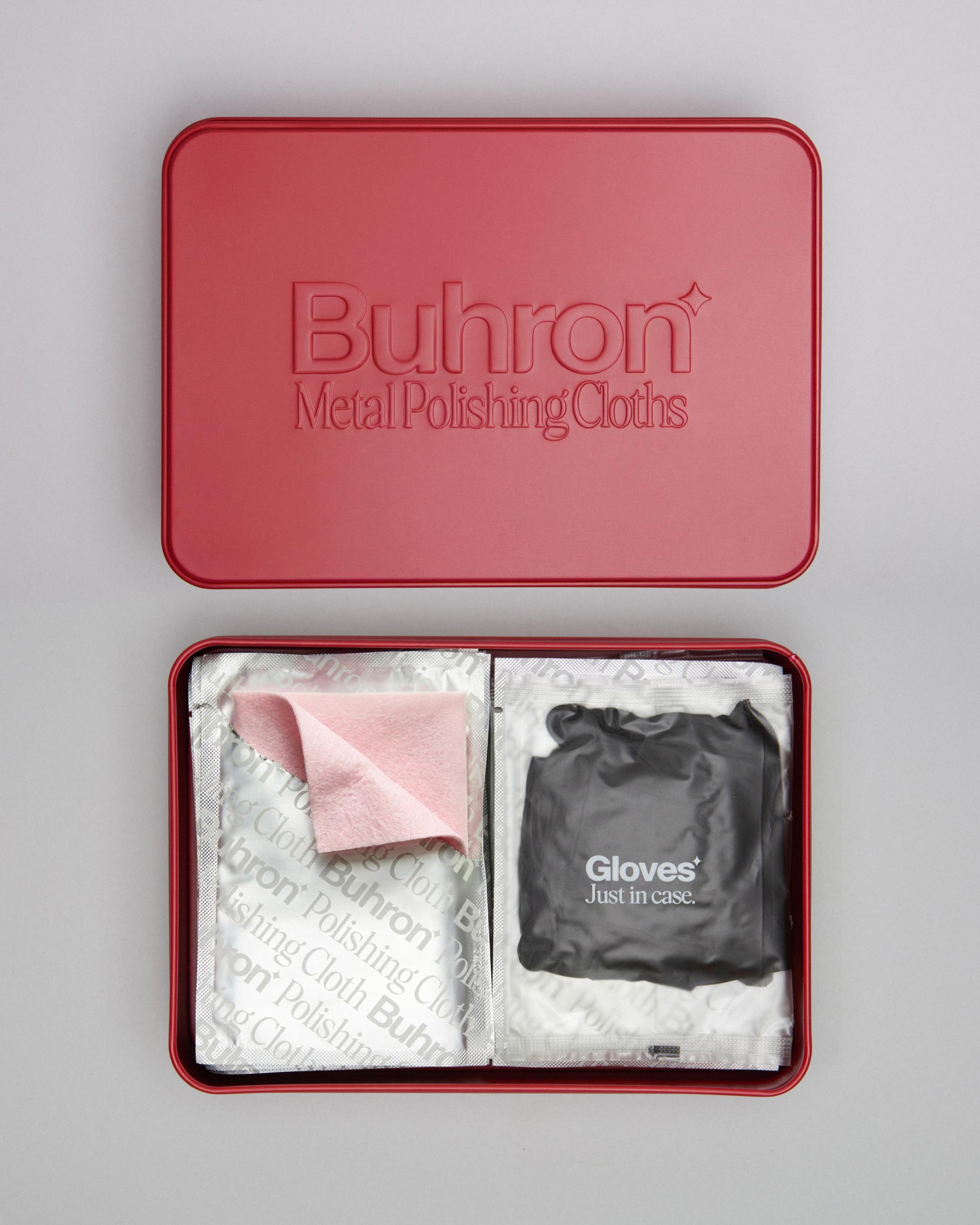 Buhron jewellery polishing kit tin open showing impregnated polishing cloths and gloves inside